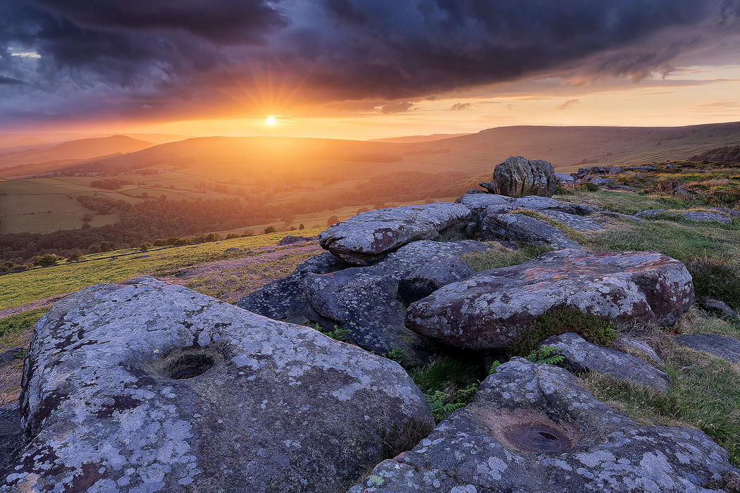 Incredible stormy sunset at the knuckle stone on Carhead rocks. Derbyshire, Peak District.