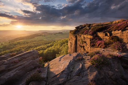 Golden hour light shining under thick dark clouds, Millstone Edge - Peak District Landscape Photography