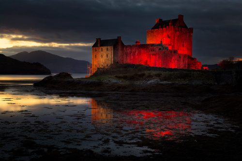 Eilean Donan castle at last light reflected in the loch.