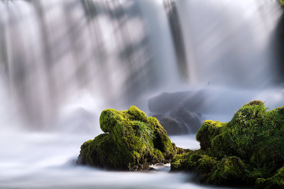 Close up detailing of the mossy vegetation below the stunning Monsal Weir. I was lucky to have some gorgeous shafts of light filtering through the cascading water behind. Derbyshire, Peak District National Park.