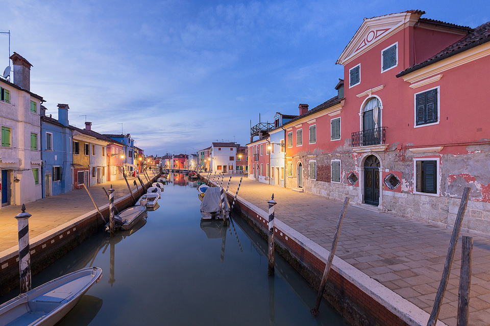 One of the many picturesque canals overlooked by the brightly coloured fishermen's houses on the Island of Burano. After a great day exploring the labyrinth of tiny streets and canals during the warm sunny day I set up to do some photography as the blue hour arrived. 