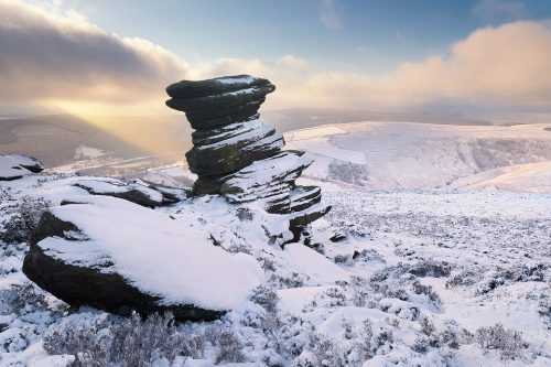 Salt Cellar in Winter. Some fantastic wintry conditions at the Salt Cellar on Derwent Edge in the Peak District National Park. I've visited this location many times over the years, never quite getting the right conditions. On this occasion hoar frost, snow, low cloud and some sublime light combined for a spectacular Winter wonderland. On this afternoon I was blessed with some stunning conditions, particularly when this well defined beam of light broke through the clouds illuminating the snowy hills in the distance. 