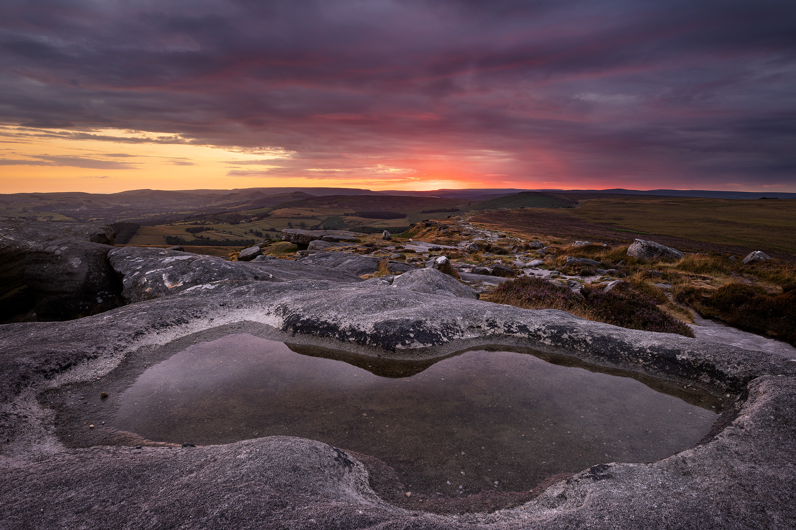 Crimson Skies Over Stanage Edge, a Sunset to Remember. A dramatic mid summer sunset from Stanage Edge, looking towards the Hope Valley. 